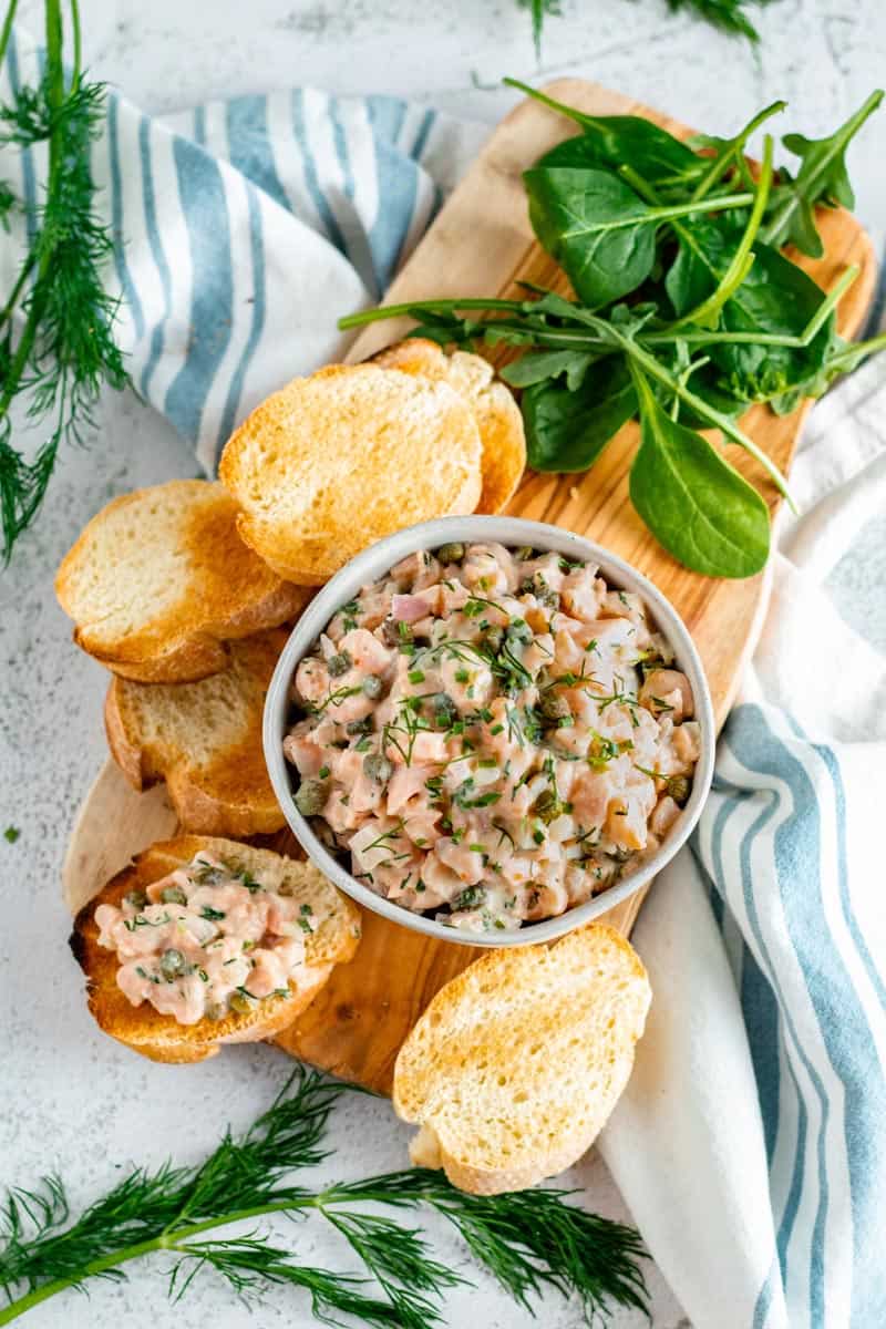 Salmon Tartare and Baguette on Cutting Board.
