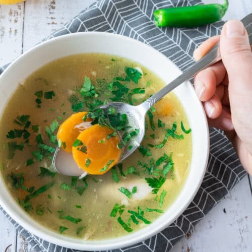 Taking a spoonful of Leftover Turkey Soup in 2 bowls.