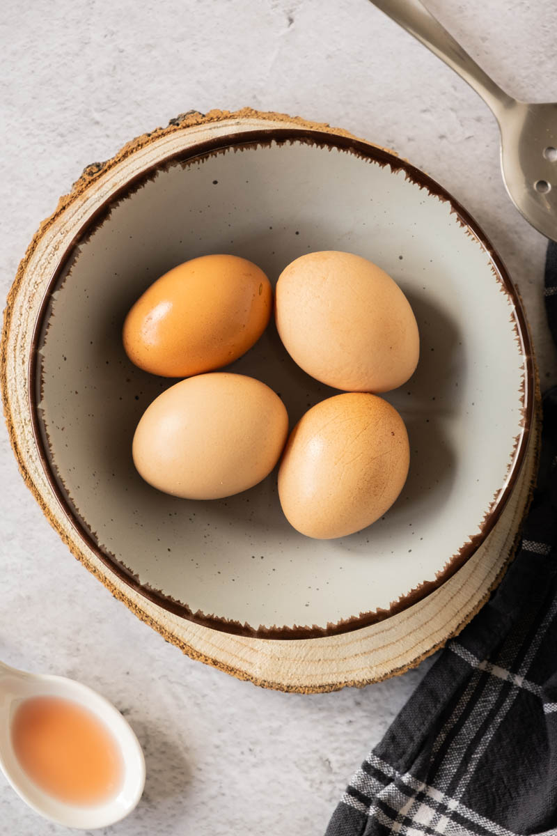 Fresh eggs in bowl.