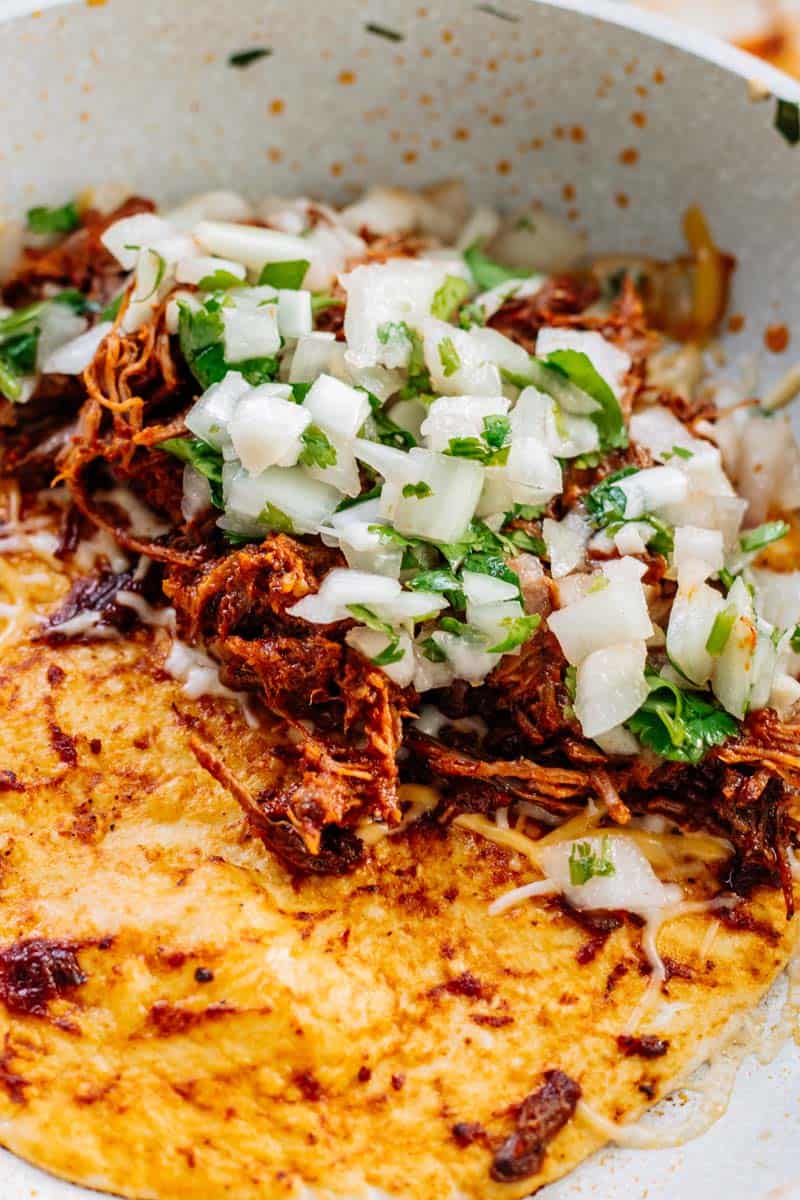 Birria taco in frypan.