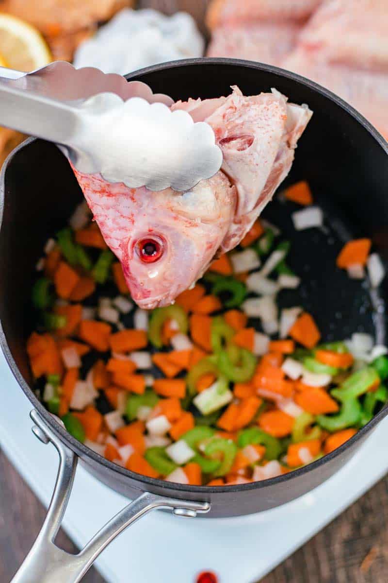 fish head in pot of vegetables