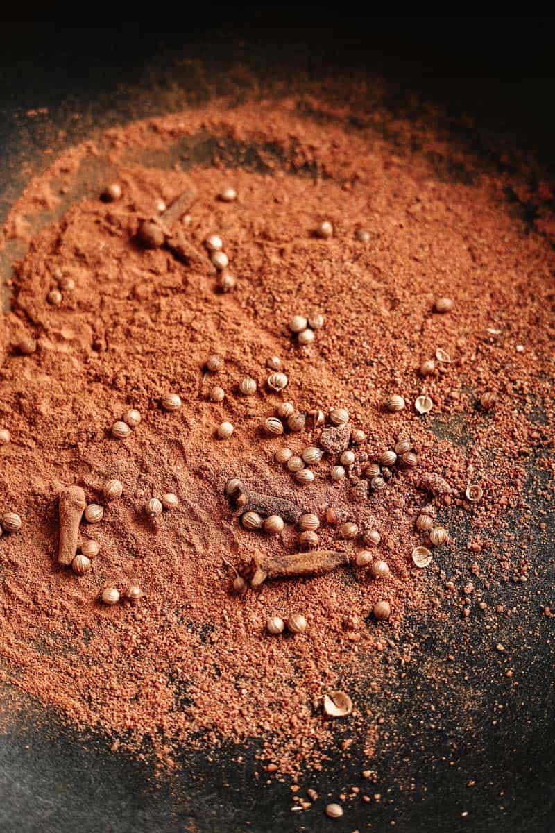 toasting masala spices in a pan
