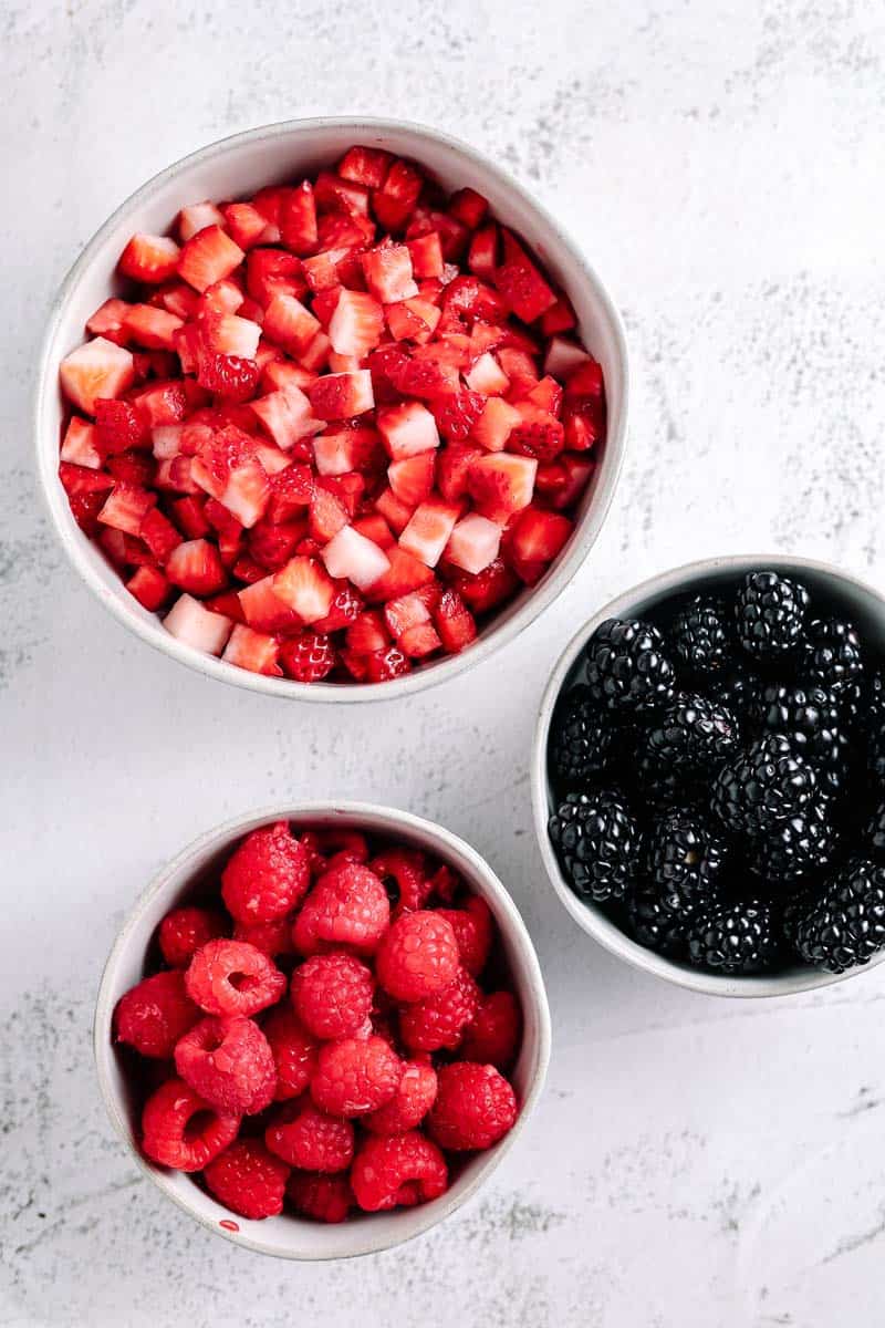 diced and whole berries in bowls