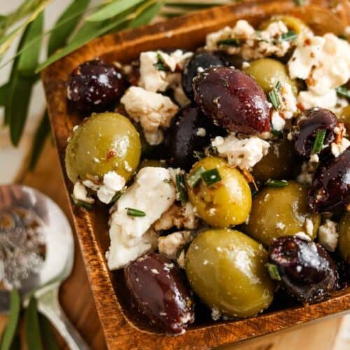 marinated greek olives and feta cheese in a dish