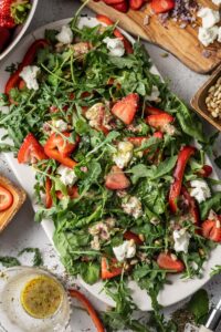 strawberry and spinach salad on a platter