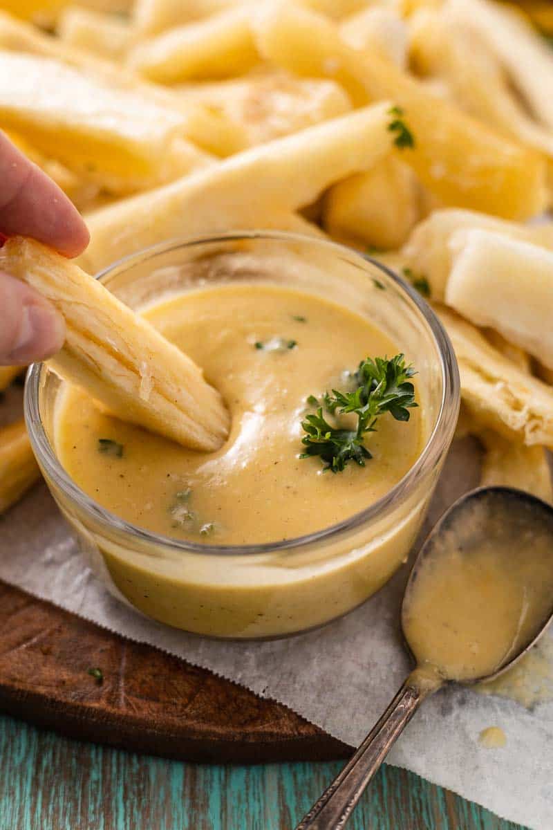dipping a yuca fry in lemon aioli