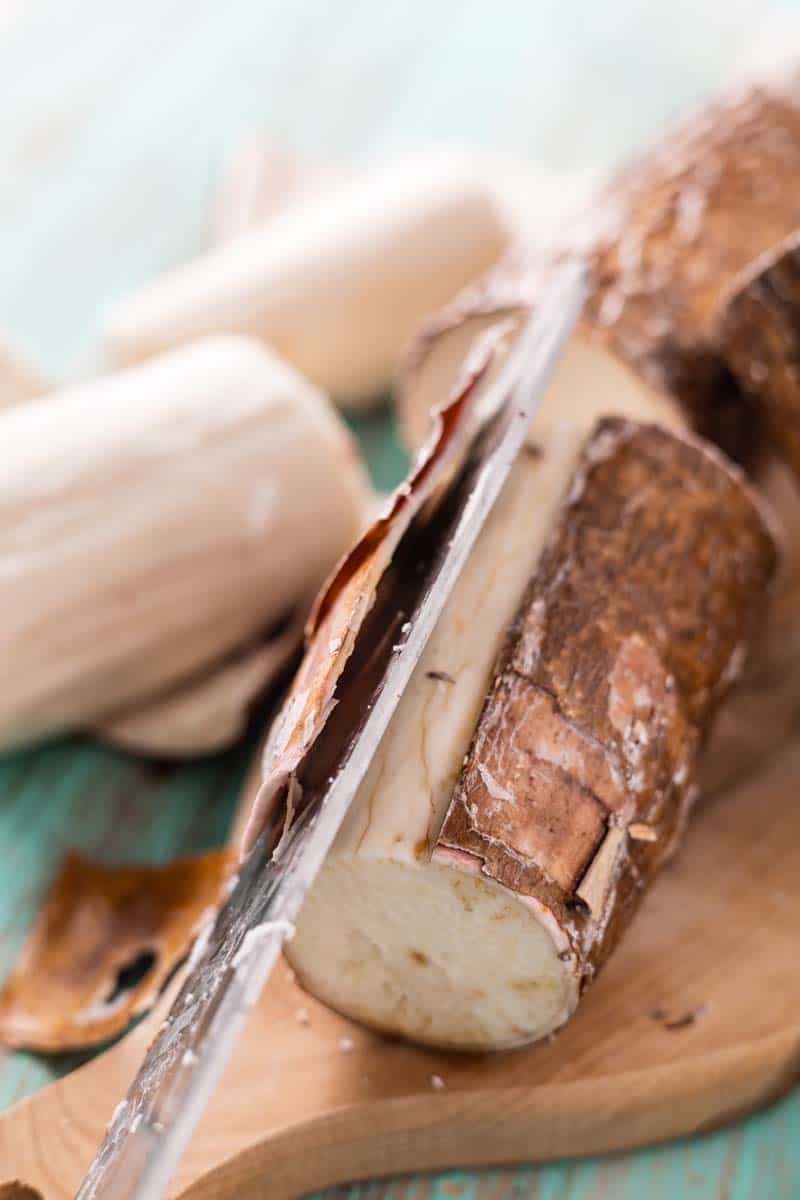 cutting the skin off yuca