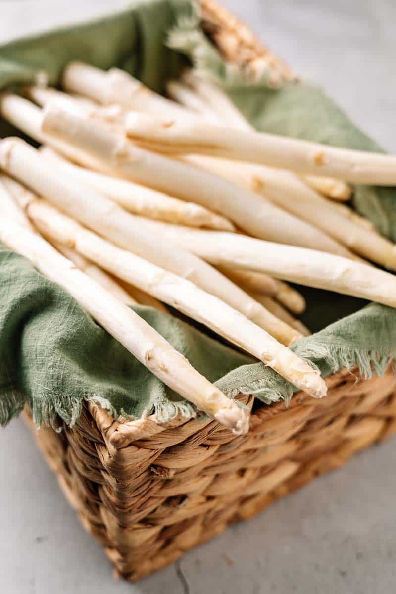 raw white asparagus in a basket