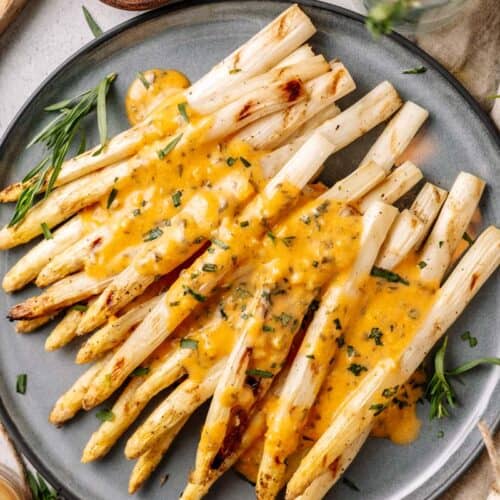 grilled white asparagus with bearnaise sauce on a plate
